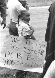 Local children marched against PCB, carrying handmade signs like Tracy Clifton